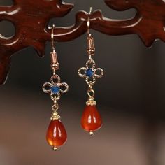 This pair of beautiful red natural stone with blue crystal drop earrings is a great addition for elegant styling. It also makes wonderful gift for your loved ones. 🌸 Please avoid water, oil and any chemical to maintain this product. 🌸 All products are made with high-quality material to give them the best durability and stylish appeal. 🌸 MATERIAL: Natural stone Gold plated  Blue crystals 🌸 SIZE & DETAILS:  Length: 1.7"(4.5cm) 🌸 SHIPPING INFORMATION All the items ship from Vancouver, BC. Depe Vintage Earrings With Natural Stones For Gift, Vintage Natural Stone Earrings For Gift, Vintage Teardrop Crystal Earrings For Gift, Red Natural Stones Drop Earrings, Red Natural Stone Drop Earrings, Sapphire Crystal Earrings For Pierced Ears As Gift, Sapphire Crystal Earrings For Pierced Ears, Bohemian Gemstone Teardrop Earrings For Gift, Sapphire Crystal Drop Earrings As Gift