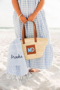 This handwoven straw tote will be your beach go-to this summer! Customize the leather patch with a monogram in your favorite colors and enjoy easy access with the open top design. Details: - Materials: Straw & PU Leather - Handwoven in Morocco - 15.7" x 10" - Long leather handle for the perfect length to fit over your arm! - Color may slightly vary due to natural material - Please enter the letters for the monogram in the EXACT order that you want them to appear. Maximum 2 characters. ---------- Shadow Monogram, Straw Tote, Top Design, Leather Patches, Open Top, Leather Handle, Favorite Color, Morocco, Design Details