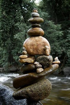 a stack of rocks sitting on top of a river