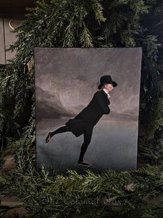 an image of a man in a top hat and coat is hanging on a christmas tree