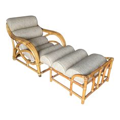 a bamboo chaise lounge chair with cushion and footrests on an isolated white background