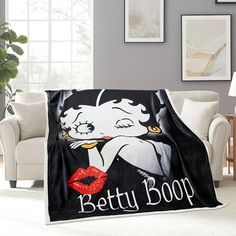 the betty boop blanket is on display in a living room