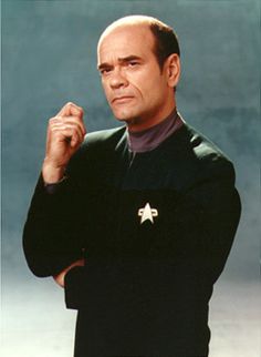 a man in a star trek uniform posing for a photo