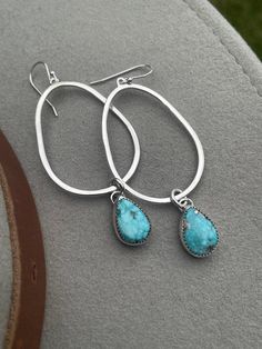 This is a pair of handcrafted sterling silver and Whitewater Turquoise dangle earrings - a gorgeous statement earring (that is relatively lightweight!) that flaunts a stunning pair of whitewater turquoise stones. The stones remind me of the ocean :)  These earrings are incredibly versatile - great dressing up an outfit with a T-shirt and jeans, and also a perfect jewelry option for dressing up for a special event! Dangling from sterling silver teardrops, these Whitewater turquoise stones add a p Artisan Turquoise Drop Earrings Jewelry, Turquoise Sterling Silver Long Drop Jewelry, Turquoise Long Drop Earrings With Ear Wire, Artisan Turquoise Dangle Jewelry, Handmade Turquoise Drop Jewelry, Unique Turquoise Dangle Jewelry, Hand Forged Sterling Silver Dangle Jewelry, Artisan Jewelry With Matching Drop Earrings, Turquoise Hand Forged Drop Earrings