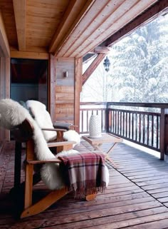 a rocking chair sitting on top of a wooden porch