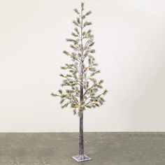 a small christmas tree with white lights on it's branches in a metal stand