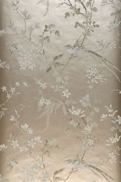 the wall paper has white flowers and leaves on it, as well as silver foil