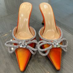 Mach & Mach's Mules Feature A Vibrant Leather Finish And Swarovski Crystal-Embellished Double Bow. Slip-On Style. Style Number: Pf22-S0009-Led-Ss042. Heal Height - 3.25”. Made In Italy. Brand New, Never Worn. Dust Bags And Box Not Included. Elegant Orange Heels, Elegant Orange Heels For Evening, Elegant Orange Evening Heels, Luxury Rhinestone Heels For Spring, Summer Embellished Patent Leather Heels, Orange Patent Leather Heels For Party, Luxury Crystal Embellished Heels For Spring, Elegant Orange Patent Leather Heels, Sparkling Heels For Evening