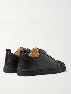 The 'Louis Junior' low-tops are a core design in Christian Louboutin's sneaker collection, and this 'Spikes' version perfectly melds the label's classic appeal and rock 'n' roll flare. They're made from smooth black leather, fitted with sleek tonal eyelets and laces, and finished with conical hardware on the toecaps. Wear them with slim, dark jeans. Streetwear Low-top Sneakers With Leather Sole, Custom Calf Leather Sneakers With Studded Outsoles, High-top Leather Sneakers With Spikes, Custom Leather Sneakers With Spikes And Round Toe, Designer Low-top Sneakers With Leather Sole, Black Sneakers With Vulcanized Sole In Calf Leather, Black Calf Leather Sneakers With Vulcanized Sole, Designer Low-top Custom Sneakers With Rubber Sole, Low-top Calf Leather Sneakers With Studded Outsoles