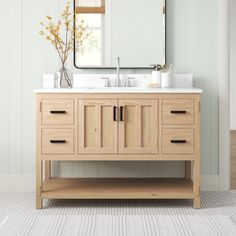 a bathroom vanity with two sinks and a large mirror above it, along with a rug on the floor