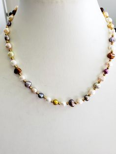 This a a beautiful multicolored seed pearl necklace. There are small gold colored beads in between each pearl. The length of this necklace is 16 inches with a 2 inch chain extender. However, I can change the extender to any length you would like or remover it altogether. There are matching earring available. Multicolor Pearl Drop Necklaces With Round Beads, Multicolor Round Beads Necklace With Pearl Drop, Multicolor Beaded Necklace With Pearl Drop, Multicolor Beaded Necklaces With Pearl Drop, Elegant Gold Pearl Necklace With Colorful Beads, Elegant Multicolor Necklaces With Gold Beads, Multicolor Pearl Drop Necklace, Chain Extenders, Seed Pearl