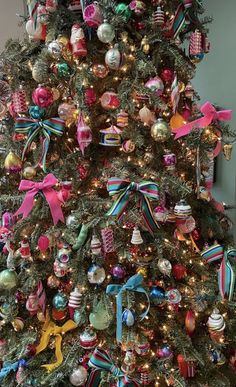 a christmas tree decorated with ornaments and ribbons