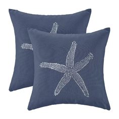 two blue pillows with white starfishs on the front and back, both in different sizes