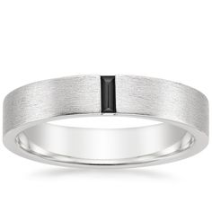 Men's 18K White Gold Apollo Black Diamond Wedding Ring. This modern men's wedding band features a vertical baguette-shaped black diamond set against a matte brushed finish for a defining look. The softened inside edge provides increased comfort for daily wear (1/15 total carat weight). White Gold Black Diamond Mens Wedding Band, Black And White Gold Mens Wedding Band, Mens Platinum Wedding Band, Platinum Ring Men, Modern Mens Wedding Rings, White Gold Mens Wedding Band, Modern Mens Wedding Bands, Mens Wedding Rings Platinum, Black Diamond Wedding Ring