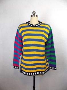 "Vintage 1980's 1990's oversized style striped sweater in colorful color block pattern. Very good vintage condition.  Label: LizWear Petites 100% cotton Size: Petite S  Length 24\" Shoulders 18\" Sleeves 23\" Bust 36\" Waist 38\" *Please note that vintage clothing and contemporary sizes can vary greatly. We take measurements of listed garments by laying the garment flat and then doubling the measurement. When considering whether a garment would fit, we suggest taking a similar garment from your own wardrobe and measure it lying flat as we do. Then compare the measurements." Multicolor Long Sleeve Sweater With Contrast Stripes, Winter Multicolor Striped Sweater, Oversized Multicolor Vintage Sweater, Retro Striped Color Block Sweater, Vintage Striped Cotton Sweater, Oversized Multicolor Retro Sweater, Vintage Multicolor Color Block Sweater, Retro Striped Crew Neck Sweater, Vintage Striped Sweater For Spring