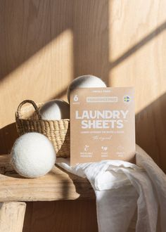 the laundry sheets are next to two balls of wool