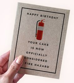 a hand holding up a card with a fire extinguisher on it that says, happy birthday your cake is now officially considered fire hazard