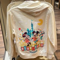 Brand New Hooded Sweatjacket Full Zip Front Embroidered And Screen Art On Back Features Mickey, Minnie, Goofy And Pluto, Plus Sleeping Beauty Castle Art, Disneyland And ''Play In The Park'' Logos Embroidered Minnie Mouse With Balloon Appliqu On Chest, Plus Sleeping Beauty Castle Screen Art Soft Knit Fabric Long Sleeves Lined Hood With Drawstring Closure Ribbed Hem And Cuffs French Terry Interior Part Of The Play In The Park Collection The Bare Necessities Body: 80% Cotton / 20% Polyester Rib: 95 Casual Hooded Sweatshirt For Disney Fan Events, Cotton Hoodie For Disney Fan Events, Cotton Hooded Hoodie For Disney Fan Events, Mickey Mouse Hooded Sweatshirt For Fall, Hooded Mickey Mouse Sweatshirt For Fall, Disney Hoodie For Fall, Disney Hoodie With Long Sleeves For Fall, Disney Long Sleeve Hoodie For Fall, White Disney Sweatshirt For Fall