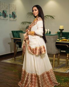 The use of broad, embroidered Tielf paired with the flowing white fabric creates a dynamic contrast, giving the dress a lively yet elegant appearance. This beautiful Habesha kemis is suitable for any kind of cultural celebrations. Material Cotton Menen Thread Estimated delivery : 4 weeks Contact WhatsApp +1(304)-306-2784Email: contact@ethiopian.store White Zari Work Dress For Traditional Ceremonies, White Dress With Zari Work For Traditional Ceremonies, White Cutdana Dress For Traditional Ceremonies, White Dress For Navratri With Traditional Drape, White Gown For Navratri Traditional Ceremonies, White Gown For Traditional Ceremonies And Festivals, Semi-stitched Dress With Resham Embroidery For Traditional Ceremonies, Semi-stitched Dress For Traditional Ceremonies With Resham Embroidery, White Maxi Sets For Traditional Ceremonies