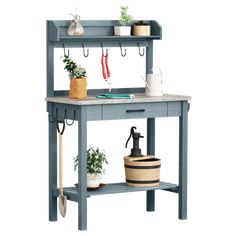 a potting bench with pots and gardening tools on the shelf next to it,