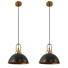 two black and gold pendant lights hanging from the ceiling with one light on each side