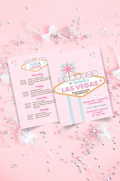 a pink and white las vegas wedding program on a pink background with silver glitters