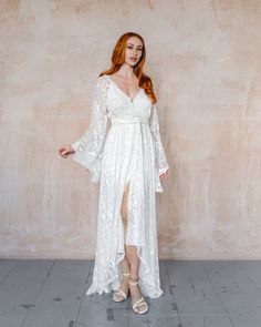 "We have a size 10 pure silk Freya ready to ship. Fits Bust 35\" Waist 28\" Hips 37\" Freya is a wrap kimono style wedding dress with a matching silk sash belt. * Ivory unlined sheer dress only * Under slip sold separately here, https://etsy.me/3EgLhZ0 * Front wrap button closure * Front hem sits approx ankle length, Hi Low effect front length approx 34\" * Sash belt included We have our other sizes available in Freya here https://etsy.me/3xLzArz" Ethereal Floor-length Maxi Dress For Wedding, Bohemian Fitted V-neck Gown, Bohemian Wedding Dress With Kimono Sleeves, Bohemian Long Sleeve Maxi Wedding Dress, Bohemian Long Sleeve Wedding Maxi Dress, Flowy Maxi Dress For Wedding Night, Bohemian Long Sleeve Maxi Dress For Wedding, Ethereal White Maxi Dress For Wedding, Ethereal White Wedding Maxi Dress