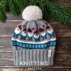 a knitted hat sitting on top of a wooden floor next to a pine tree