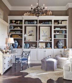 a living room filled with furniture and a chandelier