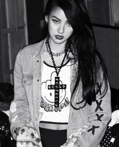 black and white photograph of a girl with long hair wearing a t - shirt that says hello kitty