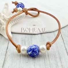 Looking for a unique gift for your loved one or maybe just a little something for yourself? Check out our Pearl and Chinoiserie Bead Bracelet for Women! This bohemian layering bracelet features beautiful blue chinoiserie glass beads and genuine freshwater pearls, hand-strung on real leather cord. Each piece is individually handmade and ships quickly from Florida. Choose from sizes 6.5 inch (small), 7.0 inch (medium - most popular), 7.5 inch (large), or 8.0 inch (xl). If you have a special request for a custom size, simply leave a note during checkout and we'll make it happen. This bracelet is perfect for anyone who loves non-metal jewelry and wants to add a touch of bohemian style to their wardrobe. To see more of our unique handmade jewelry, check out our shop: https://bohemeltd.etsy.com. Bohemian Single Strand Beaded Bracelets As Gift, Adjustable Single Strand Bracelet As Gift, Layering Jewelry, Blue Chinoiserie, Bracelet For Her, Great Gifts For Women, Layered Jewelry, Unique Handmade Jewelry, Layered Bracelets