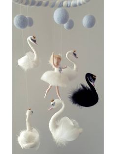 there is a mobile made to look like a ballerina and some birds hanging from it