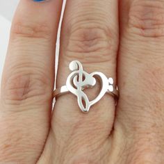 Treble Clef Bass Heart Ring - 925 Sterling Silver - Music Note Song Musician Art Ring Details: Treble Bass Clef Heart Ring is made of genuine 925 Sterling Silver Stamped 925 Ring is available in sizes 6, 7, 8, 9, and 10. Dimensions: Heart is 15mm high Band width: 2mm Arrives in a gift box Shipping Details: All orders are shipped within 1 business day (excluding US Holidays) All orders are shipped from Texas, USA International Buyers: Please see Shipping & Payments tab regarding Customs Fees Return Details: Risk-Free 30-Day Return Policy Customer Service: 9am to 4pm PST Monday-Friday (excluding US Holidays) Please message us with any questions! Aquamarine Engagement Ring Rose Gold, Crystal Point Jewelry, Silver Earrings Aesthetic, Art Jewelry Ring, Art Nouveau Engagement Ring, Music Note Ring, Music Rings, Black Diamond Wedding Bands, Musician Art