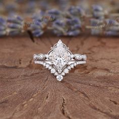 an engagement ring on top of a wooden table