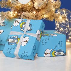 three wrapped presents under a christmas tree