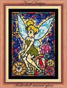 a stained glass window with a tinkerbell sitting on top of it