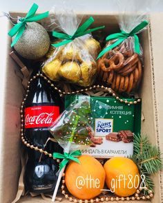 an open box filled with assorted christmas treats and snacks, including pretzels