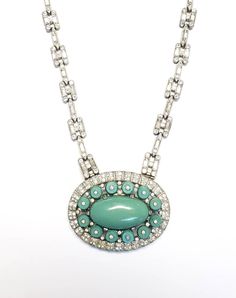 "Art Deco Czech Glass Turquoise Necklace Rhinestone Chain Necklace 19\" Long Check out this incredible, glamourous Art Deco Czechoslovakian & Rhinestone necklace that pairs perfect for a ball or wedding. This striking, and one of kind unique stunner features a cluster of donut and oval cabochon turquoise Czech glass surrounded by smaller, white round cut rhinestones. The necklace is equally impressive with baguette and small round rhinestones throughout the entire band that embodies the luxuriou Elegant Turquoise Necklaces With Diamond Accents, Elegant Turquoise Necklace With Diamond Accents, Turquoise Diamond Pendant Necklace, Turquoise Oval Stone Necklaces, Oval Turquoise Necklaces With Stones, Turquoise Oval Stone Necklace, Oval Turquoise Stone Necklace, Turquoise Cabochon Necklace For Formal Occasions, Formal Turquoise Cabochon Necklace