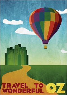 a colorful hot air balloon flying over a lush green field