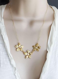 "Three little gold plated lily flowers dancing in a line topped with a fresh water pearl. Photo shows the flowers on a 18\" 14 KT gold fill chain. Spring clasp closure Matching earrings : https://www.etsy.com/listing/75898763/gold-flower-earrings-white-coin-pearl?ref=shop_home_active_22 Photoed with a 16\" chain on model H A N D M A D E * We hand make all pieces in our Water Mill New York studio * We source eco friendly packaging and materials, including recyclable mailers! FREE BOX AND WRAP ON Gold Pearl Necklace With Flower Charm, Delicate Gold Necklace With Flower Decoration, Gold Necklaces With Flower Decoration For Wedding, Gold Necklace With Flower Decoration For Wedding, Gold Pearl Flower Necklace For Gift, Delicate Gold Flower Necklace, Elegant Gold Flower Necklace For Wedding, Gold Pearl Flower Jewelry, Gold Pearl Flower Necklace