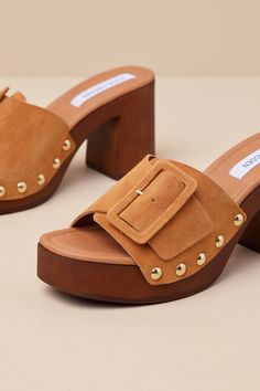 We bet the compliments will never end when you're wearing the Steve Madden Marlena Sand Suede Leather Studded Platform Sandals! These mule-inspired sandals have a soft, genuine suede leather construction that shapes a wide toe strap with an oversized adjustable buckle detail, all atop an almond-shaped footbed. Shiny studded details adorn the 1"" toe platform, while a wood-look block heel creates a flirty finish! 3. 5" wood-look block heel. Lightly cushioned insole. Nonskid rubber sole. Genuine l Suede Mules With Buckle Closure And Open Heel, Suede Open Toe Mules With Heel Loop, Open Toe Suede Mules With Heel Loop, Luxury Suede Open Toe Mules, Luxury Open Toe Suede Mules, Luxury Open Toe Clogs With Removable Insole, Luxury Suede Mules For Summer, Designer Suede Heels With Buckle Closure, Designer Suede Closed Toe Sandals