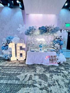 the table is set up with balloons and decorations