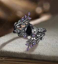 a black diamond ring sitting on top of a book