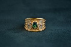 A mid-century inspired ring (Byzantine/Etruscan), that is made with solid Sterling Silver (925 silver). The outer layer is 22K Gold-plated, and in the middle there is an oval cz Emerald. Around it, there are 6 small white CZs. Byzantine Ring, Byzantine Gold, Byzantine Rings, Byzantine Jewelry, Greek Ring, Medieval Rings, Gold Amethyst Ring, Handmade Sterling Silver Rings, Greek Jewelry