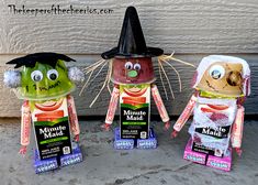 three halloween decorations made to look like they are wearing witches hats and holding candy bar wrappers