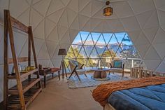 a bedroom with a large window overlooking the mountains