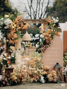 an outdoor wedding setup with flowers and greenery