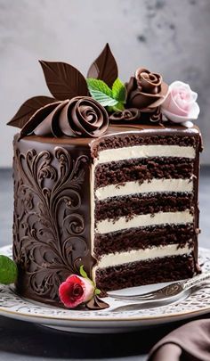 a piece of chocolate cake with white frosting and flowers on the top is sitting on a plate