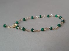 A beautiful, minimalist bracelet with deep green emerald rondelles Please measure tightly your wrist's circumference, using a ribbon or something similar, and then measuring the ribbon with a ruler. When ordering, please select the actual wrist size, not the size of the bracelet. I will make the bracelet fit your wrist, by adding approx 0.6 inch to the circumference. The bracelet was set up using gold filled wire and genuine emerald faceted rondelles. Available also with rose gold filled  or sterling silver findings. The bracelet is adjustable.  The listed gemstones can be replaced with others of your choice;  please convo me for custom orders.  Emerald is a stone of great harmony, wisdom and love, domestic bliss, sensitivity, loyalty, memory, mental capacity, harmony, focus, eliminating n Faceted Beads Bracelets As May Birthstone Gift, Faceted Beads Bracelet For May Birthstone Gift, May Birthstone Bracelets With Faceted Beads As Gift, May Birthstone Faceted Beads Bracelet, May Birthstone Spacer Beads Jewelry Gift, Green Rondelle Bracelets For Jewelry Making, Green Onyx Beaded Bracelets As Gift, Gift Jewelry With Spacer Beads For May Birthstone, Elegant Green Wire Wrapped Beaded Bracelets