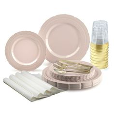 a table setting with plates, forks and utensils on top of each other